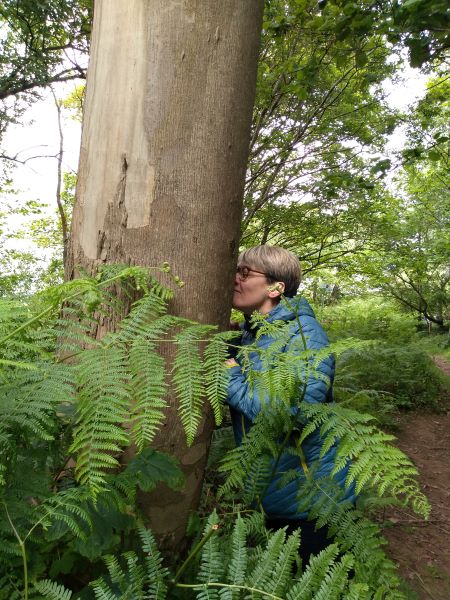 A person sniffing a tree