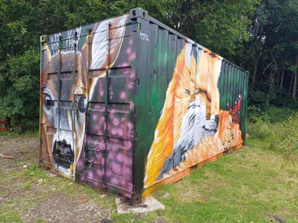 Storage container painted with murals of a roe deer and fox with peacock butterfly