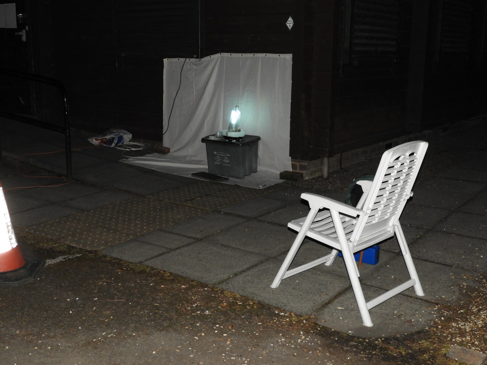 Trap with bright light set up on a table and camp chair in foreground